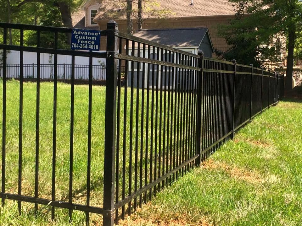 Black aluminum picket fence enclosing a residential lawn by Advanced Custom Fence in Charlotte, NC