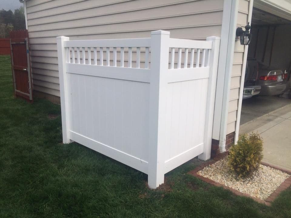 White vinyl privacy fence with lattice-top panels beside a home by Advanced Custom Fence in Charlotte, NC